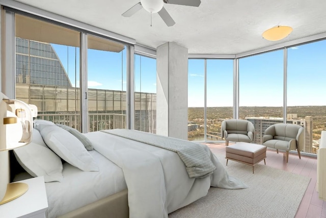 360 Nueces St Unit 3504, Austin, TX 78701 - bedroom with a wall of windows and wood finished floors