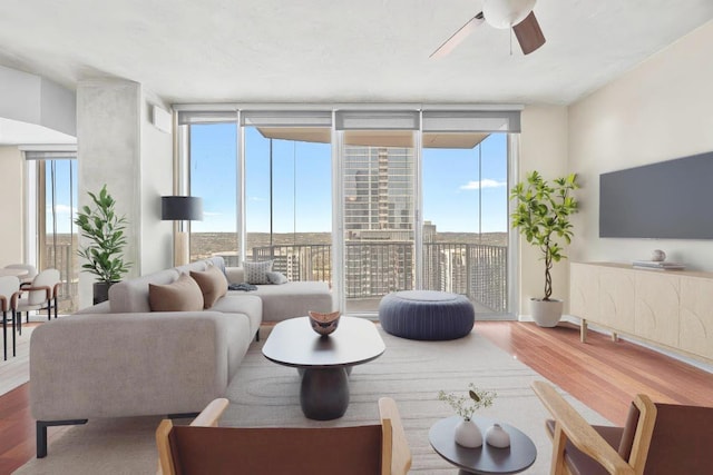 360 Nueces St Unit 3504, Austin, TX 78701 - living room with expansive windows, wood finished floors, healthy amount of natural light, and ceiling fan