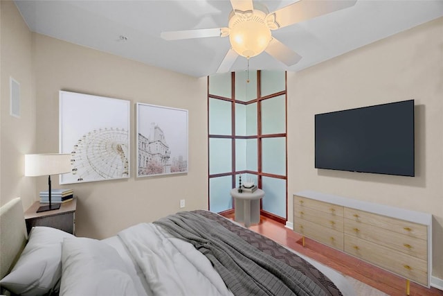 360 Nueces St Unit 3504, Austin, TX 78701 - bedroom featuring wood finished floors, a ceiling fan, and baseboards