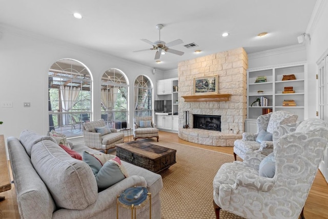 5305 Cuesta Verde, Austin, TX 78746 - living room featuring ornamental molding, a ceiling fan, light wood finished floors, a stone fireplace, and recessed lighting