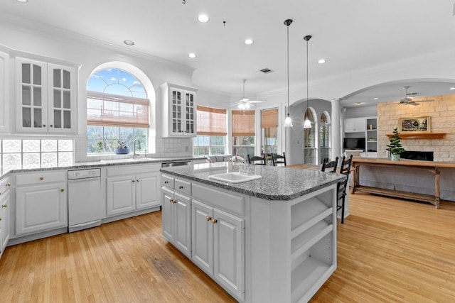 5305 Cuesta Verde, Austin, TX 78746 - kitchen featuring ceiling fan, ornate columns, a fireplace, arched walkways, and crown molding