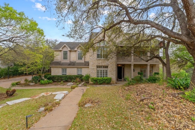 5305 Cuesta Verde, Austin, TX 78746 - traditional-style house with a balcony, a front lawn, and stone siding