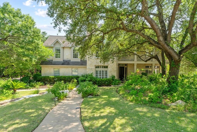 5305 Cuesta Verde, Austin, TX 78746 - view of front of property featuring stone siding, a front lawn, and a balcony
