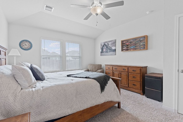 bedroom featuring light colored carpet, visible vents, a ceiling fan, and vaulted ceiling