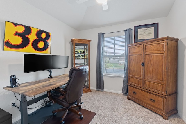 office area with light colored carpet, lofted ceiling, baseboards, and a ceiling fan