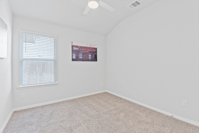 unfurnished room with vaulted ceiling, baseboards, visible vents, ceiling fan, and carpet