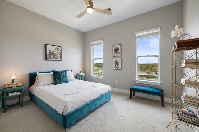 4501 Jackson Ave Unit 5205, Austin, TX 78731 - bedroom with multiple windows, light carpet, baseboards, and a ceiling fan
