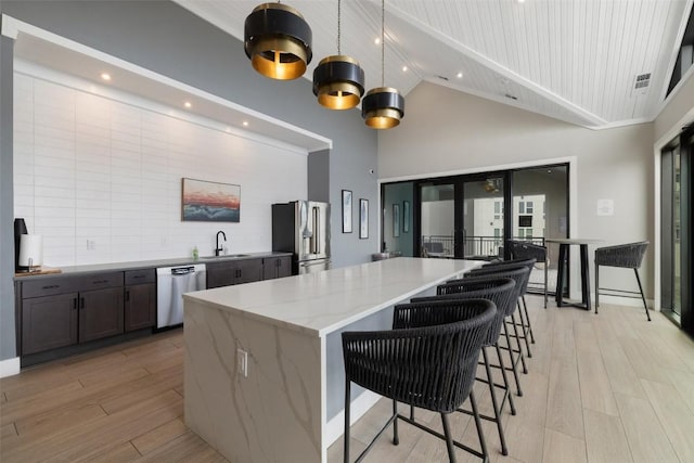 4501 Jackson Ave Unit 5205, Austin, TX 78731 - kitchen featuring stainless steel appliances, high vaulted ceiling, french doors, a center island, and light wood-type flooring
