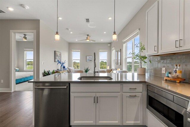 4501 Jackson Ave Unit 5205, Austin, TX 78731 - kitchen with stainless steel appliances, a ceiling fan, a sink, open floor plan, and recessed lighting