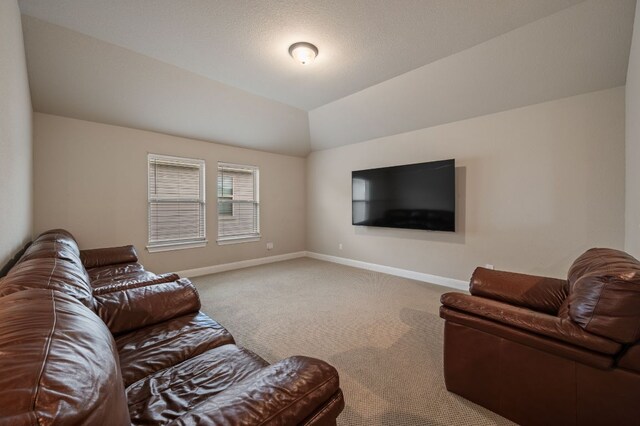 carpeted living room with baseboards and vaulted ceiling