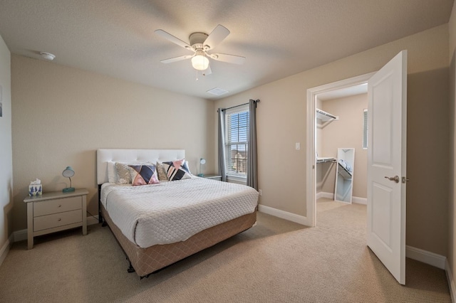 bedroom featuring light carpet, a ceiling fan, visible vents, and baseboards