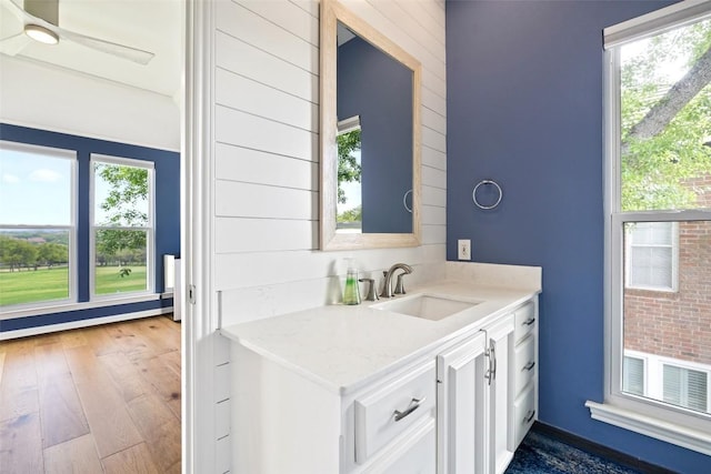 16 Tournament Way Unit 19, The Hills, TX 78738 - kitchen featuring white cabinetry, dark wood-type flooring, a ceiling fan, light stone counters, and a baseboard radiator