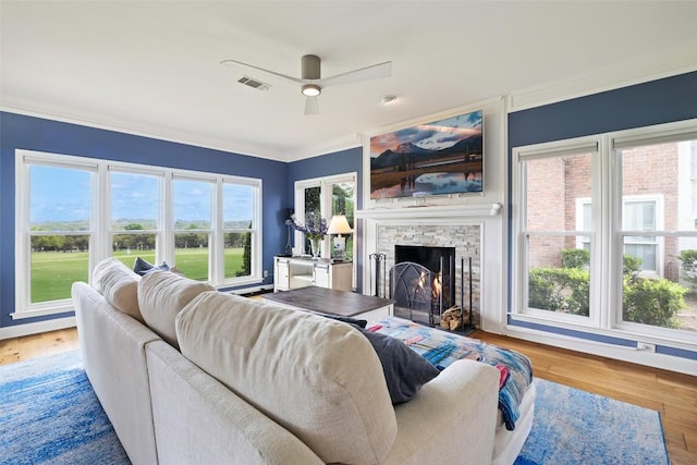 16 Tournament Way Unit 19, The Hills, TX 78738 - living area featuring a fireplace, ceiling fan, crown molding, and wood finished floors