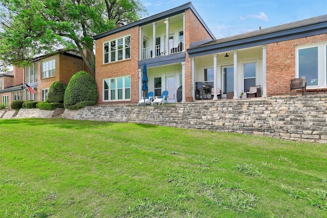 16 Tournament Way Unit 19, The Hills, TX 78738 - back of house with brick siding, a yard, and a balcony