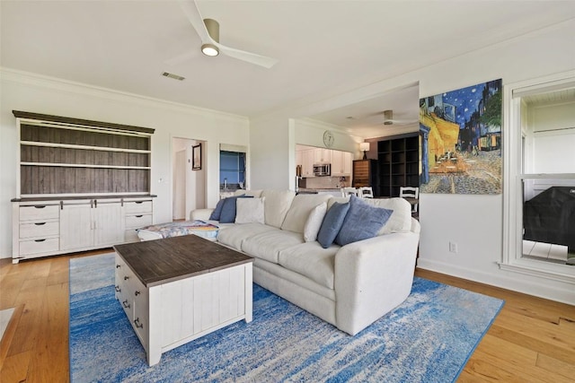 16 Tournament Way Unit 19, The Hills, TX 78738 - living area featuring ornamental molding, wood finished floors, and a ceiling fan