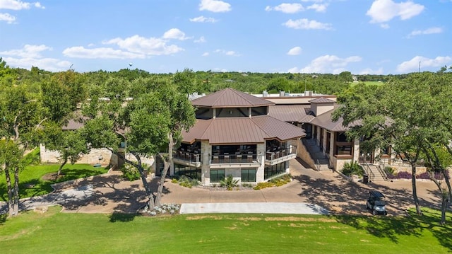 16 Tournament Way Unit 19, The Hills, TX 78738 - back of property with stone siding and a metal roof