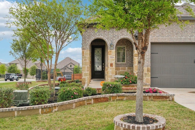 7529 Desert Needle Dr, Lago Vista, TX 78645 - doorway to property with an attached garage, brick siding, stone siding, and concrete driveway