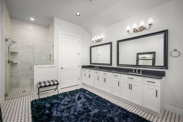 full bath with lofted ceiling, recessed lighting, a shower stall, a sink, and double vanity