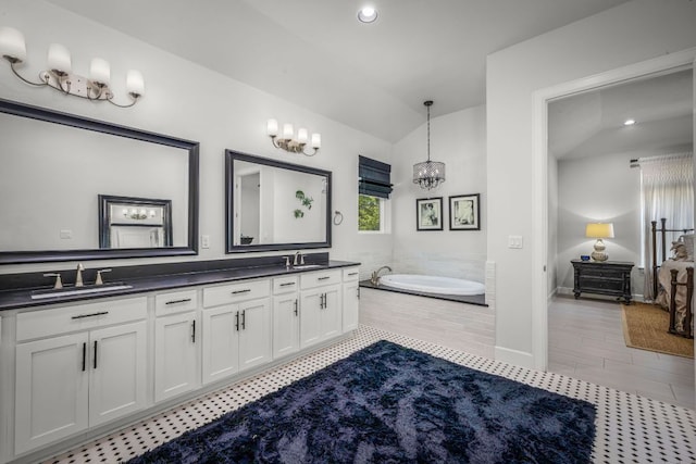 full bath with lofted ceiling, a sink, an inviting chandelier, and tile patterned flooring
