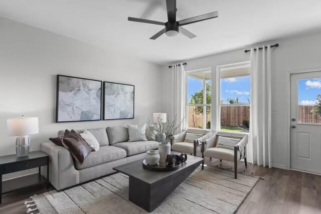13312 Lapoynor St, Manor, TX 78653 - living room with wood finished floors, plenty of natural light, and a ceiling fan