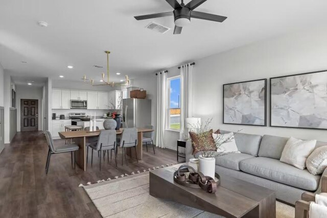 13312 Lapoynor St, Manor, TX 78653 - living area with a chandelier, wood finished floors, a ceiling fan, and recessed lighting