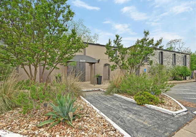 5820 Berkman Dr Unit 119, Austin, TX 78723 - view of property exterior with uncovered parking and stucco siding
