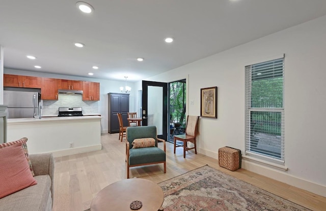 5820 Berkman Dr Unit 119, Austin, TX 78723 - living area with light wood-type flooring, baseboards, recessed lighting, and a chandelier