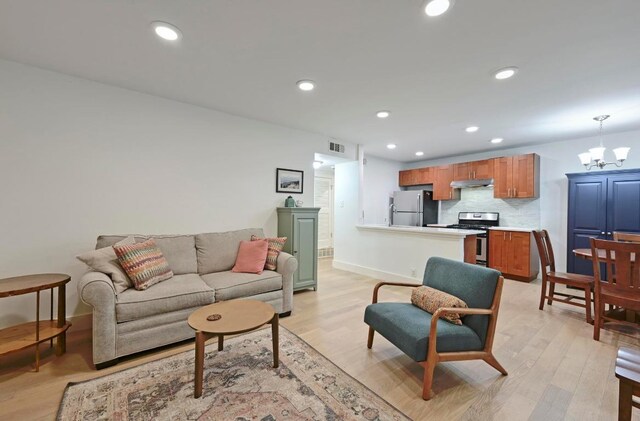 5820 Berkman Dr Unit 119, Austin, TX 78723 - living area with light wood-type flooring, a chandelier, recessed lighting, and baseboards
