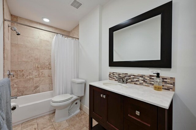 5820 Berkman Dr Unit 119, Austin, TX 78723 - full bathroom featuring decorative backsplash, toilet, vanity, shower / bathtub combination with curtain, and baseboards