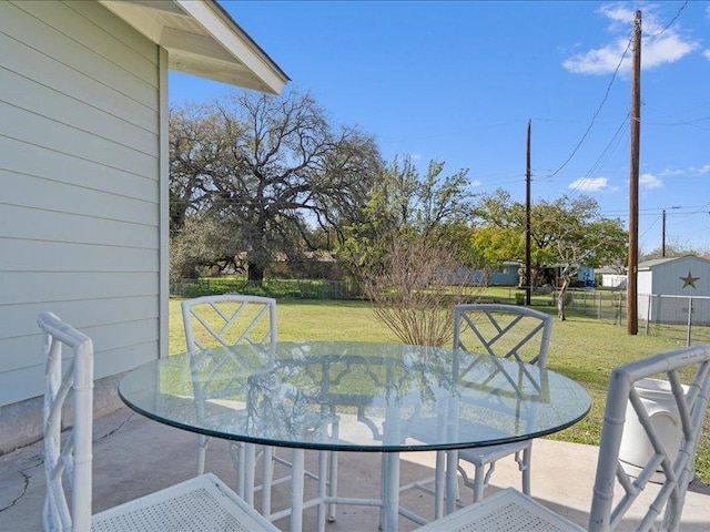 exterior space featuring outdoor dining area and fence
