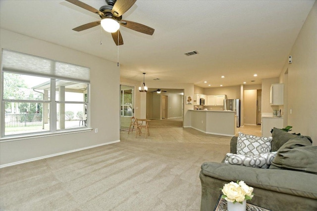 202 Whippoorwill Cv, Georgetown, TX 78633 - living area featuring light carpet, baseboards, and a ceiling fan