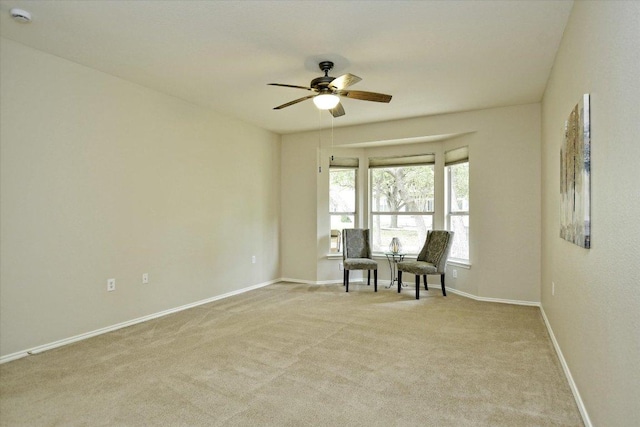 202 Whippoorwill Cv, Georgetown, TX 78633 - living area featuring a ceiling fan, light carpet, and baseboards