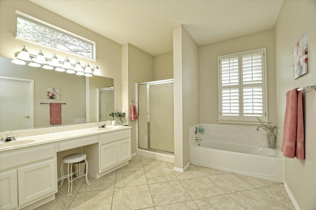 202 Whippoorwill Cv, Georgetown, TX 78633 - full bath with a garden tub, double vanity, a shower stall, tile patterned flooring, and plenty of natural light