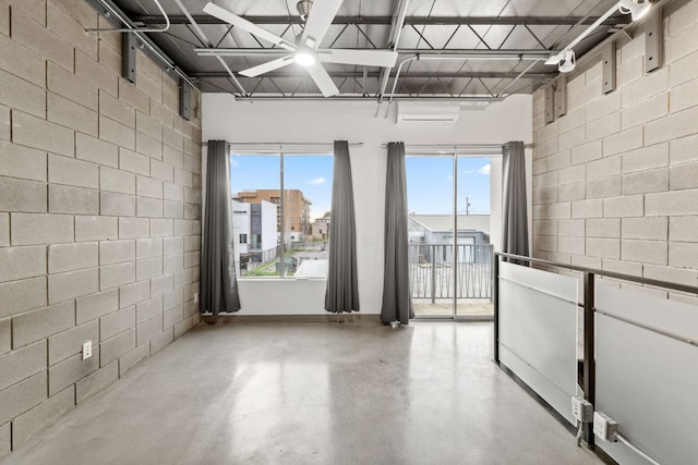 4801 S Congress Ave Unit H2, Austin, TX 78745 - spare room with finished concrete flooring, concrete block wall, and plenty of natural light