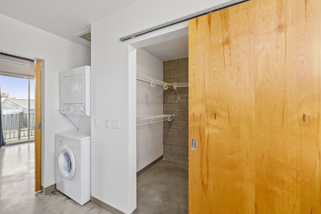 4801 S Congress Ave Unit H2, Austin, TX 78745 - washroom featuring stacked washer and clothes dryer and baseboards
