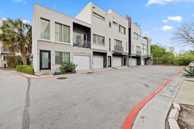4801 S Congress Ave Unit H2, Austin, TX 78745 - view of building exterior with a residential view and an attached garage