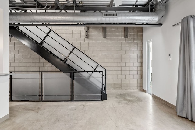4801 S Congress Ave Unit H2, Austin, TX 78745 - basement featuring baseboards and concrete block wall