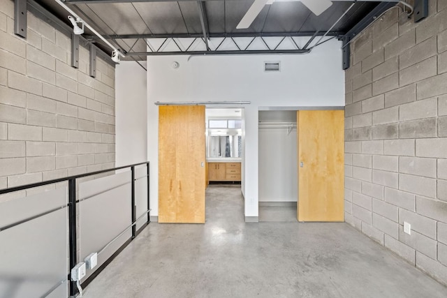 4801 S Congress Ave Unit H2, Austin, TX 78745 - interior space featuring finished concrete floors, a high ceiling, and concrete block wall