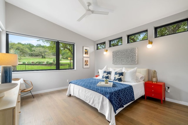 3931 R O Dr, Spicewood, TX 78669 - bedroom featuring wood finished floors, lofted ceiling, baseboards, and ceiling fan
