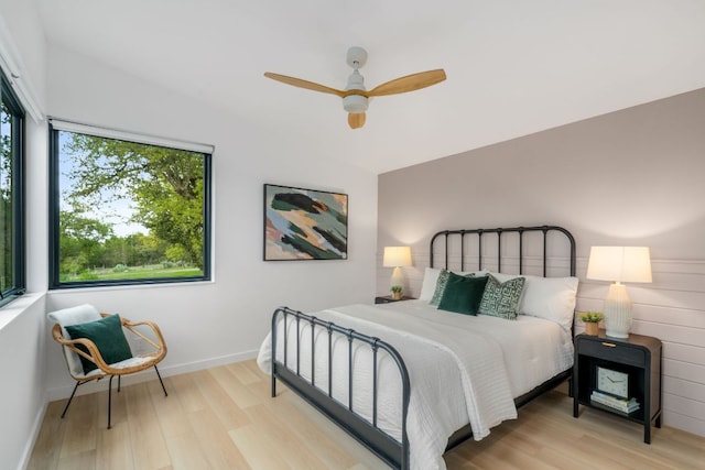 3931 R O Dr, Spicewood, TX 78669 - bedroom with light wood finished floors, baseboards, and ceiling fan