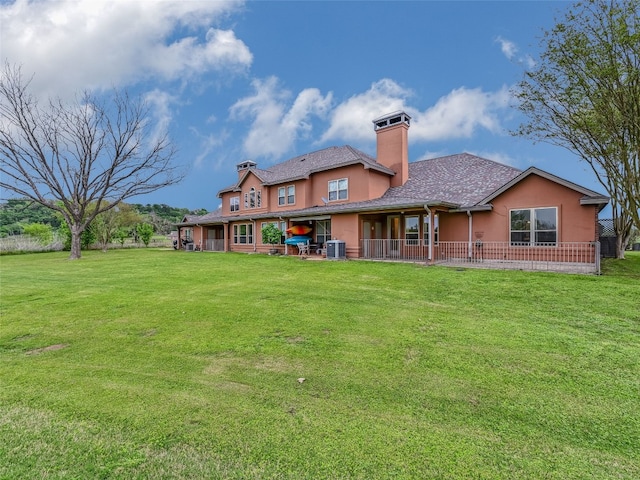539 Colovista Pkwy Unit C103, Bastrop, TX 78602 - back of property with a chimney, stucco siding, and a lawn