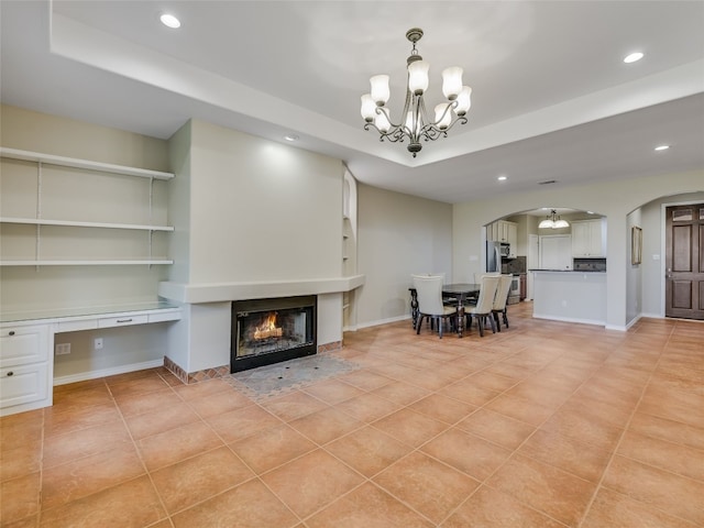 539 Colovista Pkwy Unit C103, Bastrop, TX 78602 - living area featuring a chandelier, arched walkways, light tile patterned floors, recessed lighting, and a multi sided fireplace