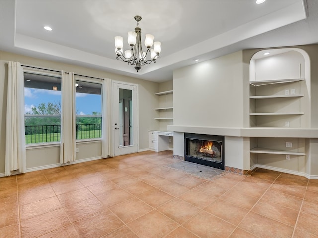 539 Colovista Pkwy Unit C103, Bastrop, TX 78602 - unfurnished living room featuring a tray ceiling, built in features, tile patterned floors, a chandelier, and recessed lighting