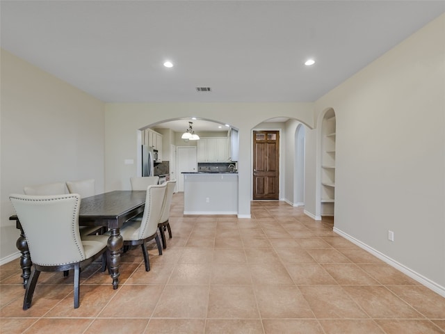 539 Colovista Pkwy Unit C103, Bastrop, TX 78602 - dining room with arched walkways, recessed lighting, baseboards, light tile patterned floors, and a chandelier