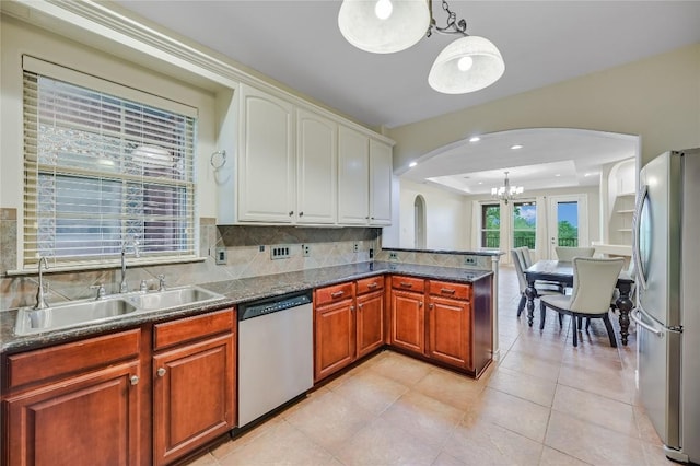 539 Colovista Pkwy Unit C103, Bastrop, TX 78602 - kitchen with stainless steel appliances, arched walkways, a sink, a chandelier, and decorative backsplash