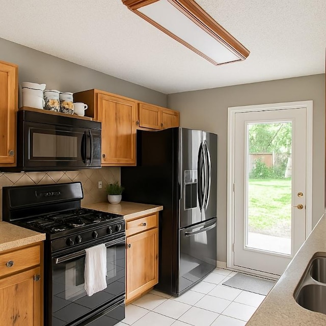 407 Trumpet Vine Trl, Cedar Park, TX 78613 - kitchen with black appliances, light tile patterned floors, decorative backsplash, light countertops, and open shelves