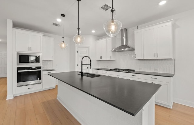 16824 Santiaguillo Trce, Manor, TX 78653 - kitchen featuring oven, built in microwave, wall chimney range hood, dark countertops, and backsplash