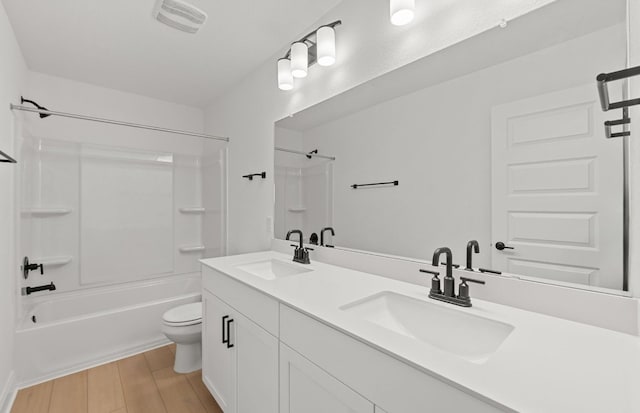 16824 Santiaguillo Trce, Manor, TX 78653 - full bath featuring shower / bathtub combination, double vanity, and wood finished floors