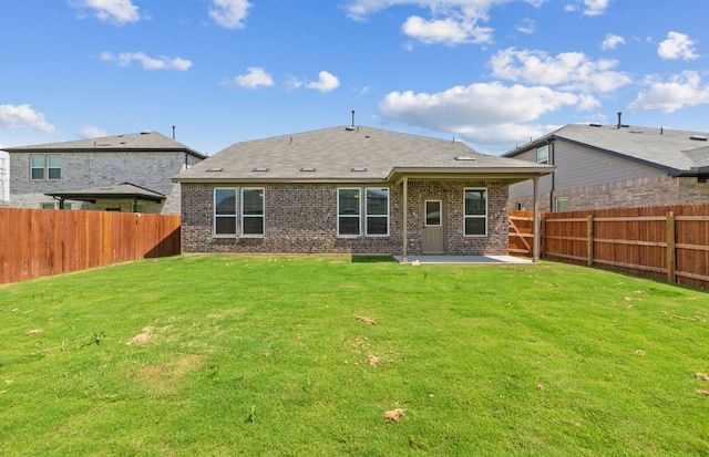 16824 Santiaguillo Trce, Manor, TX 78653 - rear view of property featuring a patio, a fenced backyard, and brick siding