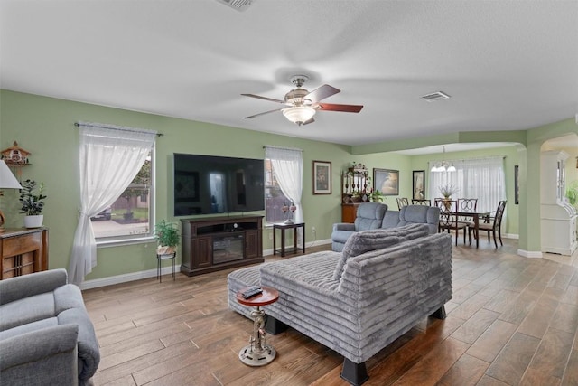 4932 Woodstock Dr, Georgetown, TX 78633 - living room featuring wood finished floors, plenty of natural light, and ceiling fan